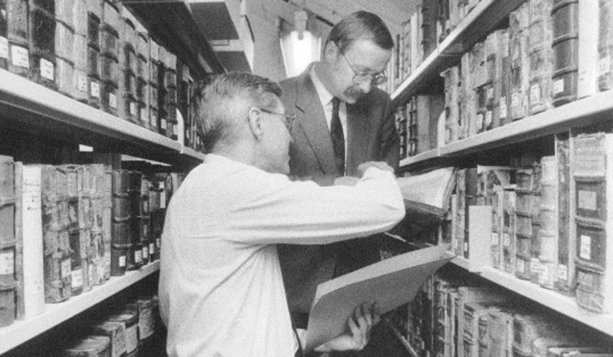 two men in an archive