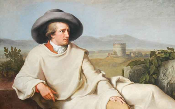 Das Bild zeigt das berühmte Gemälde "Goethe in der römischen Campagna" von J.W. Tischbein. Goethe, mit Hut und im weißen Reisemantel sitzt auf einem efeuumrankten, antiken Ruinenfragment, neben ihm ein antikes Relief.