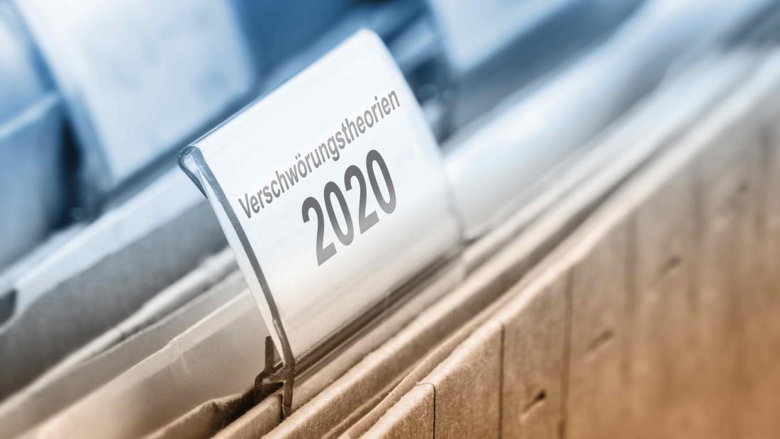 Aktenordner in einem Hängeregister, einer davon mit der Beschilderung "Verschwörungstheorien 2020".